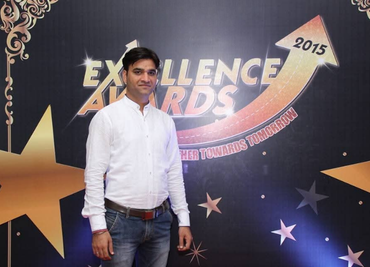 Praveen in front of atkinsrealis banner